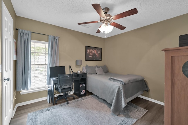17214 Shadow Valley Dr, Spring, TX 77379 - bedroom featuring wood finished floors, a desk, a textured ceiling, and ceiling fan
