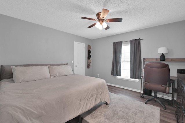17214 Shadow Valley Dr, Spring, TX 77379 - bedroom featuring dark wood-style floors, an office area, a textured ceiling, and ceiling fan