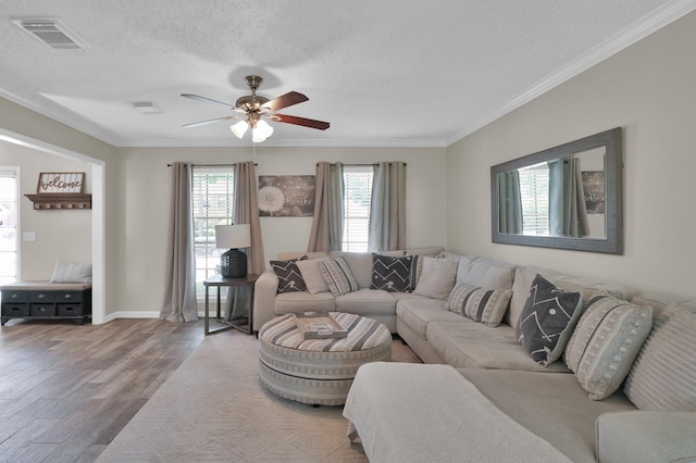 17214 Shadow Valley Dr, Spring, TX 77379 - living area featuring crown molding, wood finished floors, a textured ceiling, and a ceiling fan
