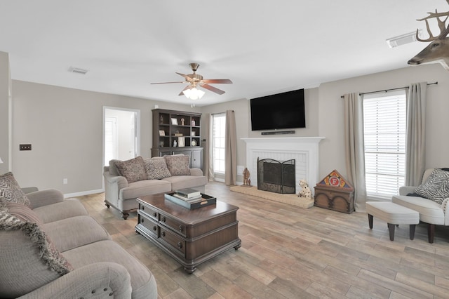 17214 Shadow Valley Dr, Spring, TX 77379 - living room with ceiling fan, light wood-style floors, plenty of natural light, and a fireplace