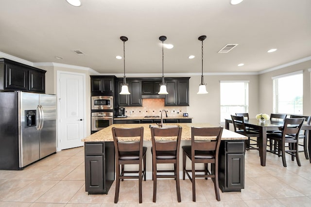 13309 Kemper Rock Ct, Rosharon, TX 77583 - kitchen featuring stainless steel appliances, light tile patterned flooring, ornamental molding, backsplash, and recessed lighting
