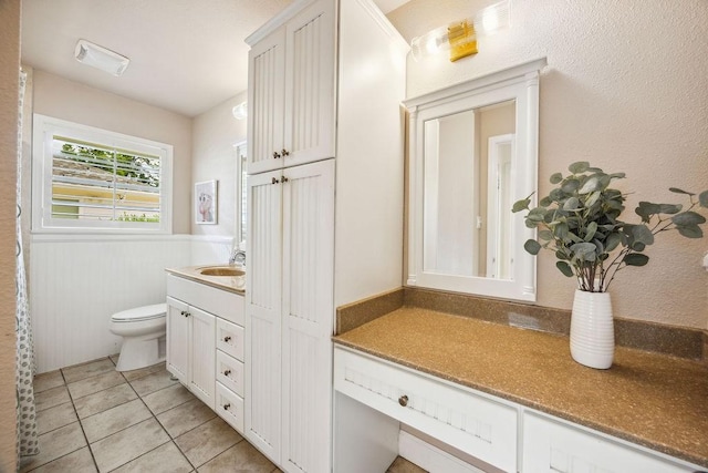 2031 Cheshire Ln, Houston, TX 77018 - bathroom featuring vanity, tile patterned floors, and a wainscoted wall