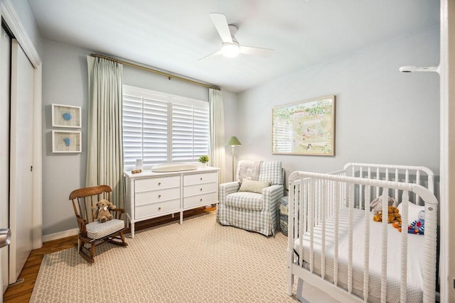 2031 Cheshire Ln, Houston, TX 77018 - bedroom featuring a closet, a crib, a ceiling fan, and wood finished floors
