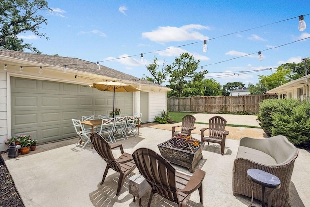 2031 Cheshire Ln, Houston, TX 77018 - view of patio with an outdoor fire pit and a garage