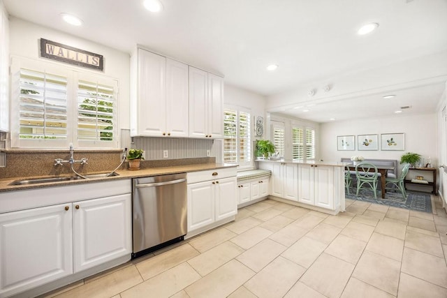 2031 Cheshire Ln, Houston, TX 77018 - kitchen featuring stainless steel dishwasher, white cabinets, tasteful backsplash, a peninsula, and recessed lighting
