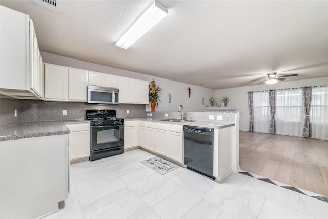 3530 Barkers Crossing Ave, Houston, TX 77084 - kitchen featuring black appliances, white cabinets, a peninsula, ceiling fan, and backsplash