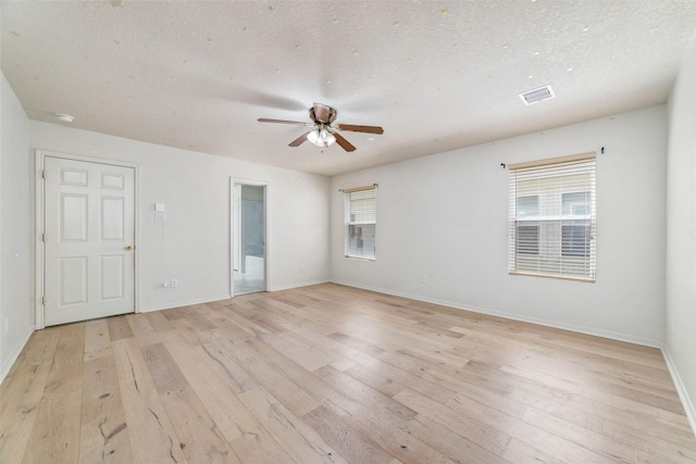 3530 Barkers Crossing Ave, Houston, TX 77084 - empty room featuring light wood-style floors, ceiling fan, a textured ceiling, and a smoke detector