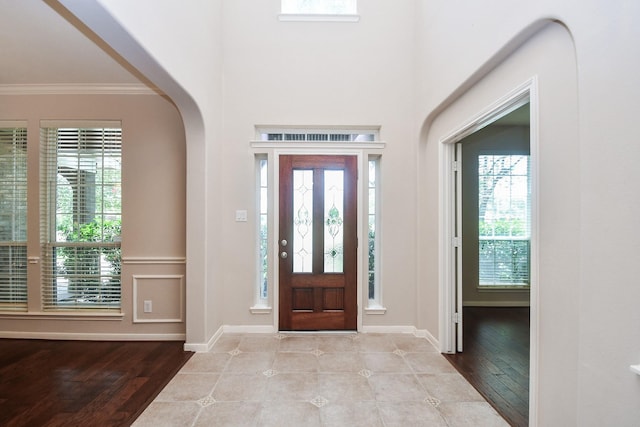 5506 Plumero Meadow Dr, Katy, TX 77494 - foyer entrance featuring ornamental molding, healthy amount of natural light, arched walkways, and wood finished floors