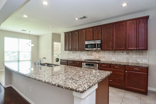 5506 Plumero Meadow Dr, Katy, TX 77494 - kitchen featuring stainless steel appliances, washer / clothes dryer, light stone countertops, decorative backsplash, and recessed lighting