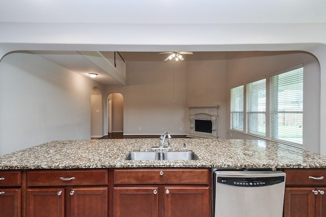 5506 Plumero Meadow Dr, Katy, TX 77494 - kitchen with dishwasher, ceiling fan, arched walkways, light stone countertops, and open floor plan