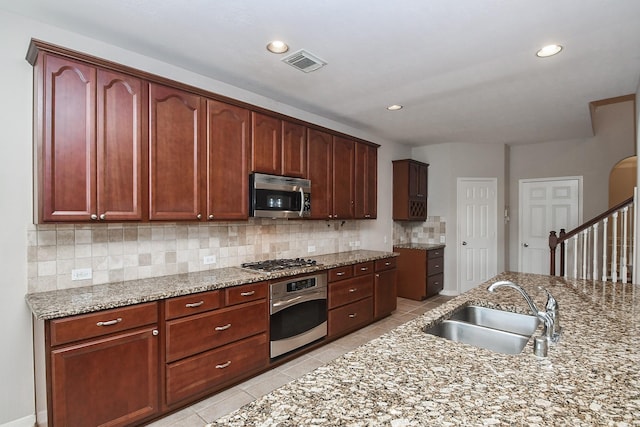 5506 Plumero Meadow Dr, Katy, TX 77494 - kitchen with stainless steel appliances, backsplash, light tile patterned flooring, light stone counters, and recessed lighting