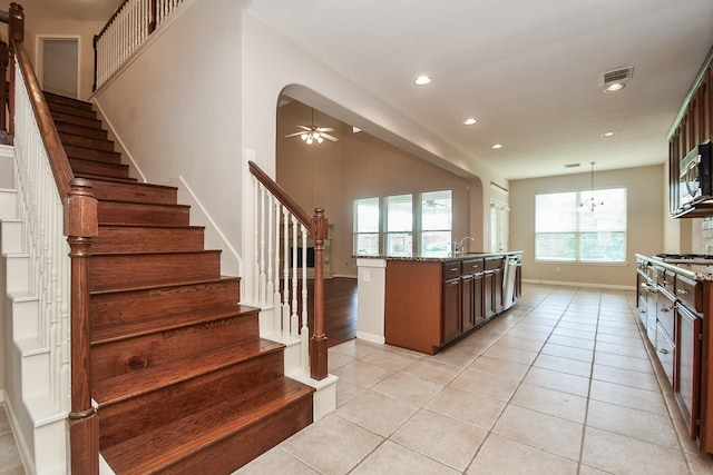 5506 Plumero Meadow Dr, Katy, TX 77494 - kitchen featuring light tile patterned floors, light stone counters, recessed lighting, appliances with stainless steel finishes, and a ceiling fan