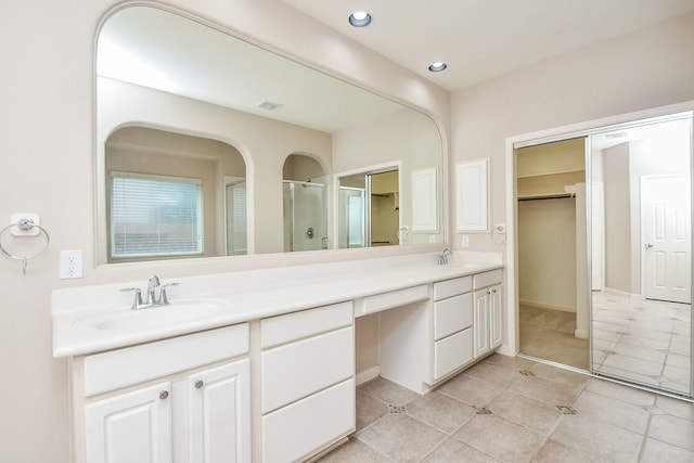 5506 Plumero Meadow Dr, Katy, TX 77494 - bathroom featuring double vanity, tile patterned floors, a stall shower, a walk in closet, and recessed lighting