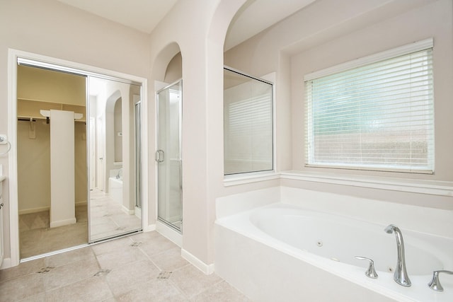 5506 Plumero Meadow Dr, Katy, TX 77494 - full bathroom with a garden tub, a shower stall, a spacious closet, vanity, and tile patterned floors
