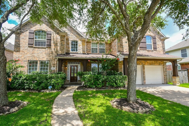 5506 Plumero Meadow Dr, Katy, TX 77494 - traditional-style home with a garage, a front yard, driveway, and stone siding