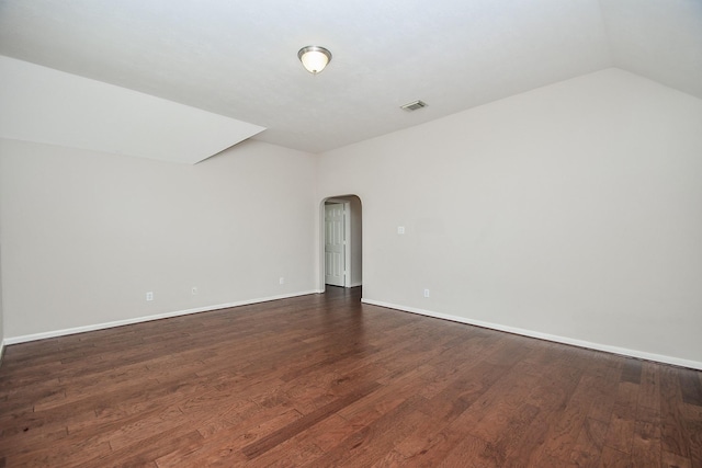 5506 Plumero Meadow Dr, Katy, TX 77494 - spare room with arched walkways, dark wood-type flooring, and lofted ceiling