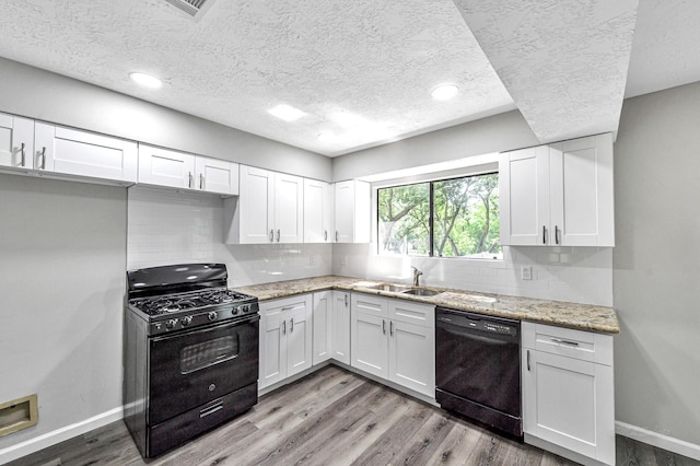 8426 Laurel Trails Dr, Houston, TX 77095 - kitchen with black appliances, a textured ceiling, white cabinetry, and recessed lighting