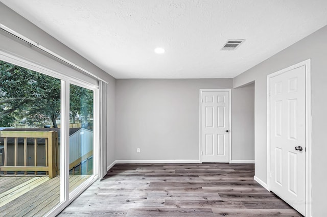 8426 Laurel Trails Dr, Houston, TX 77095 - unfurnished room with wood finished floors, recessed lighting, and a textured ceiling