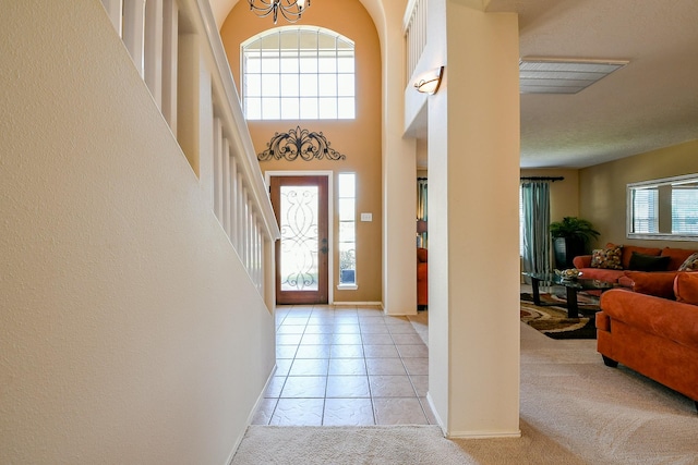 18303 June Forest Dr, Humble, TX 77346 - foyer entrance with a chandelier, stairway, a towering ceiling, and light carpet