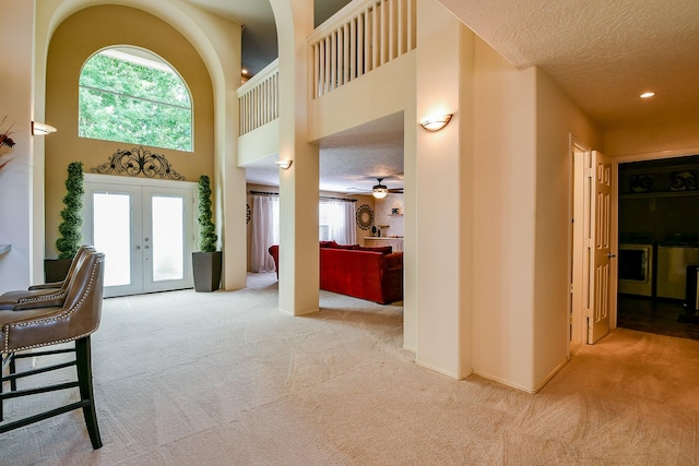18303 June Forest Dr, Humble, TX 77346 - carpeted entryway featuring french doors, plenty of natural light, a high ceiling, a textured ceiling, and recessed lighting