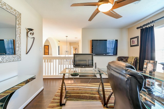 18303 June Forest Dr, Humble, TX 77346 - living room featuring a ceiling fan, wood finished floors, and arched walkways