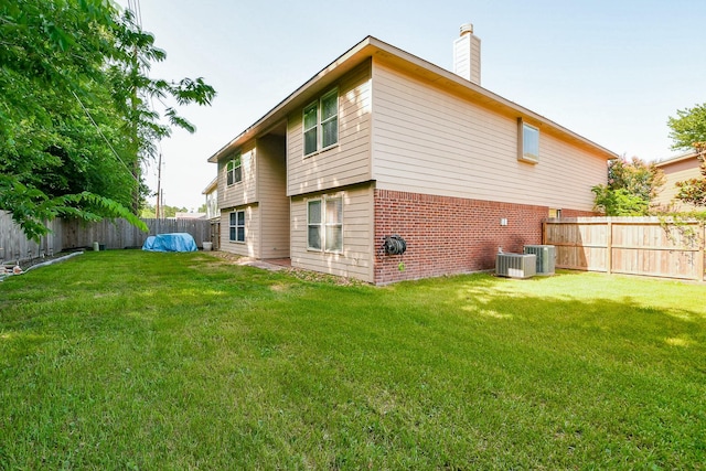 18303 June Forest Dr, Humble, TX 77346 - rear view of property featuring brick siding, a chimney, and a fenced backyard