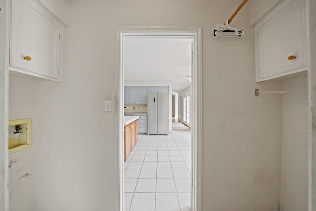 10803 Shawnbrook Dr, Houston, TX 77071 - laundry room with washer hookup, light tile patterned floors, and cabinet space