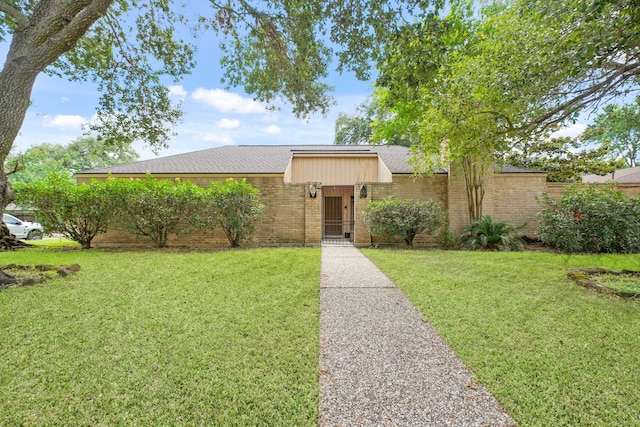 10803 Shawnbrook Dr, Houston, TX 77071 - mid-century home with a front yard, a shingled roof, and brick siding