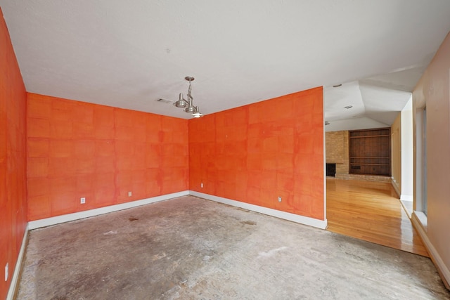 10803 Shawnbrook Dr, Houston, TX 77071 - unfurnished room with a fireplace, vaulted ceiling, and concrete flooring