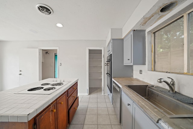 10803 Shawnbrook Dr, Houston, TX 77071 - kitchen with white electric stovetop, light tile patterned flooring, tile countertops, a kitchen island, and stainless steel dishwasher