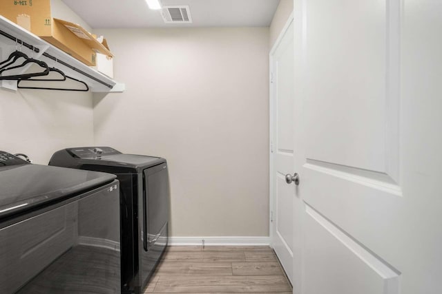 1925 Viva Rd, Bryan, TX 77807 - washroom featuring washer and clothes dryer and light wood-style flooring