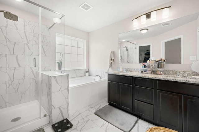 1925 Viva Rd, Bryan, TX 77807 - bathroom featuring a garden tub, a shower stall, marble look tiles, and double vanity