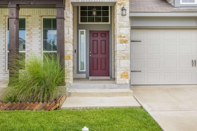 1925 Viva Rd, Bryan, TX 77807 - entrance to property featuring stone siding, a garage, and driveway