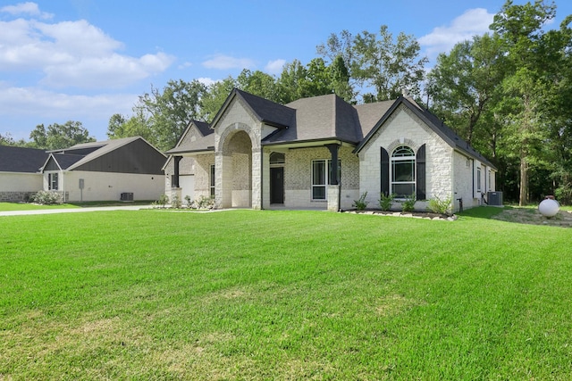 1284 Rd 66112, Dayton, TX 77535 - french provincial home with brick siding, a front yard, and a shingled roof
