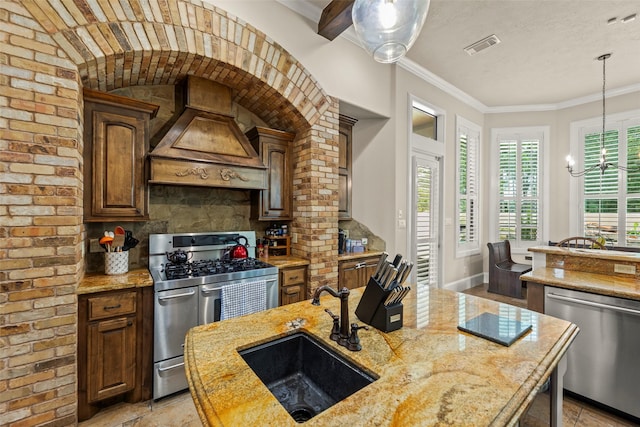 27514 Siandra Creek Ln, Spring, TX 77386 - kitchen featuring premium range hood, appliances with stainless steel finishes, backsplash, light stone counters, and a chandelier