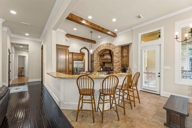 27514 Siandra Creek Ln, Spring, TX 77386 - kitchen featuring stainless steel refrigerator with ice dispenser, recessed lighting, a peninsula, crown molding, and brown cabinets