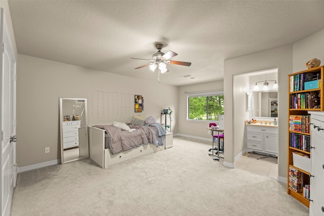 27514 Siandra Creek Ln, Spring, TX 77386 - bedroom with light colored carpet, ensuite bathroom, a textured ceiling, and a ceiling fan