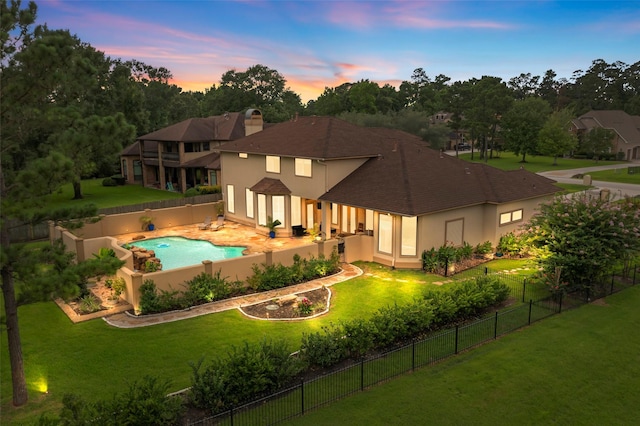 27514 Siandra Creek Ln, Spring, TX 77386 - back of property at dusk featuring a fenced backyard, stucco siding, and a shingled roof