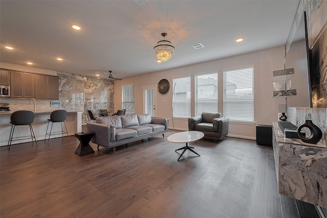 7702 Kenora Way, Richmond, TX 77407 - living room featuring recessed lighting, dark wood-style floors, and a chandelier