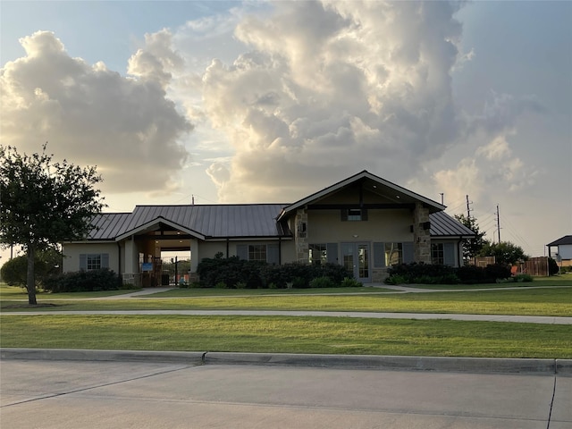 7702 Kenora Way, Richmond, TX 77407 - view of front of property featuring stucco siding, a standing seam roof, a front lawn, stone siding, and a metal roof