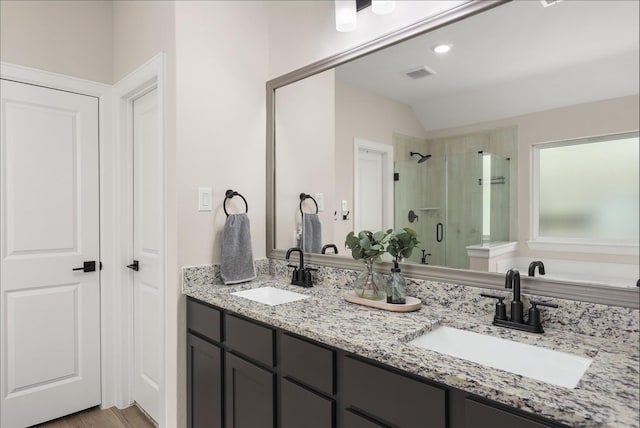 13709 Gaff Rig Dr, Texas City, TX 77510 - bathroom with a stall shower, double vanity, vaulted ceiling, and wood finished floors