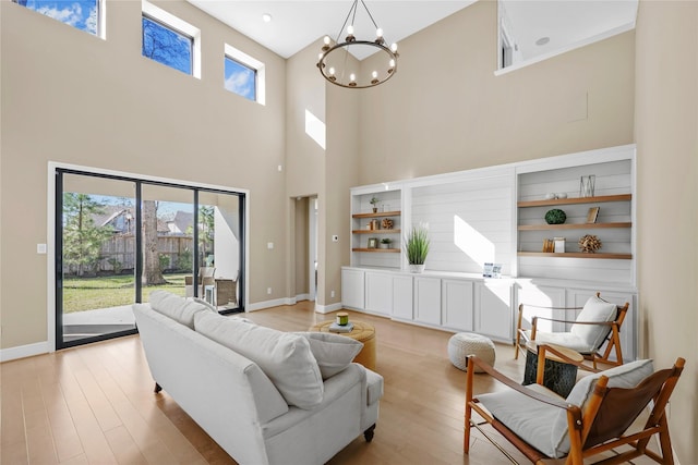 21726 Grayson Highlands Way, Porter, TX 77365 - living area with a towering ceiling, light wood-style flooring, and a chandelier