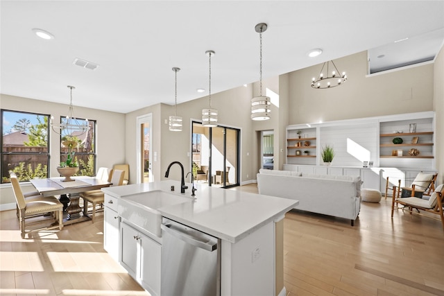 21726 Grayson Highlands Way, Porter, TX 77365 - kitchen with stainless steel dishwasher, a chandelier, light wood finished floors, light countertops, and recessed lighting
