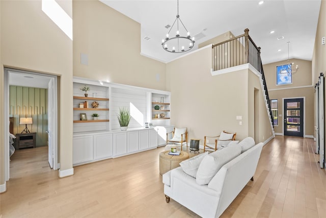 21726 Grayson Highlands Way, Porter, TX 77365 - living room with a towering ceiling, a chandelier, light wood-style floors, and recessed lighting