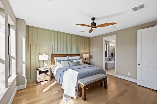 21726 Grayson Highlands Way, Porter, TX 77365 - bedroom featuring wood finished floors, ensuite bath, and a ceiling fan