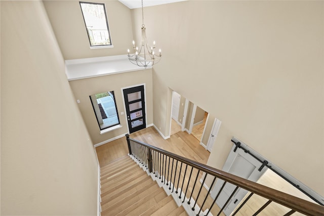 21726 Grayson Highlands Way, Porter, TX 77365 - entrance foyer with a chandelier, wood finished floors, a high ceiling, and stairway