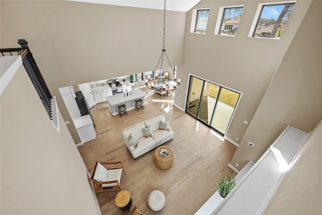 21726 Grayson Highlands Way, Porter, TX 77365 - living room with a high ceiling, a chandelier, and wood finished floors