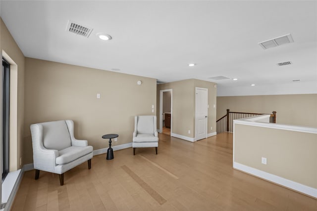 21726 Grayson Highlands Way, Porter, TX 77365 - sitting room with light wood finished floors, recessed lighting, and an upstairs landing