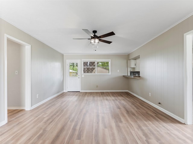 1705 Spruce St, Bay City, TX 77414 - unfurnished living room featuring crown molding, ceiling fan, and light wood-style floors