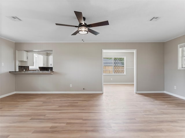 1705 Spruce St, Bay City, TX 77414 - unfurnished living room with crown molding, a ceiling fan, and light wood-style flooring